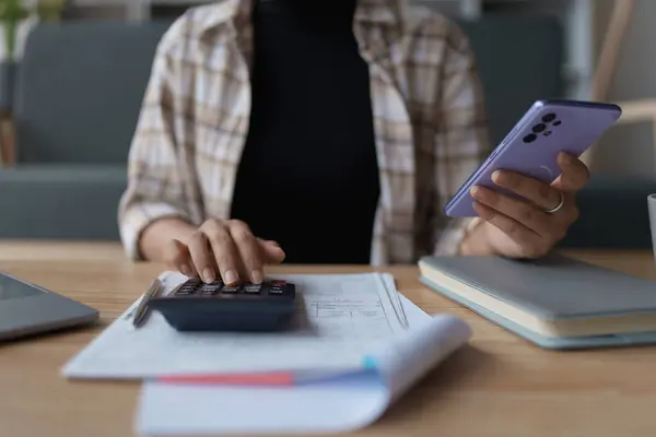 stock image Smart Mortgage Planning woman using a calculator to make Calculations and Consideration.