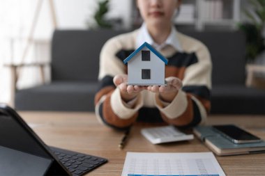 Hesap makinesi, bilgisayar ve belge kullanan Kadın Ev Finansmanı Yönetimi Hesaplama için ipotek.