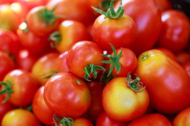 The beautiful juicy background of ripe tomatoes