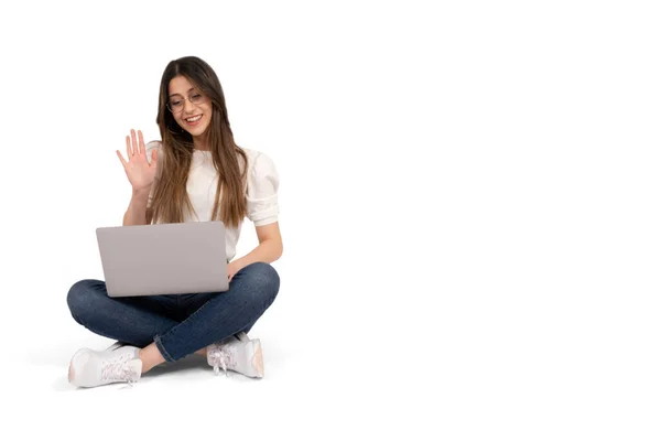 stock image E-learning concept, caucasian 20s university student e-learning concept. Sitting on the ground, holding laptop wave hand. Distance education. Attending online  webinar. Isolated white background.