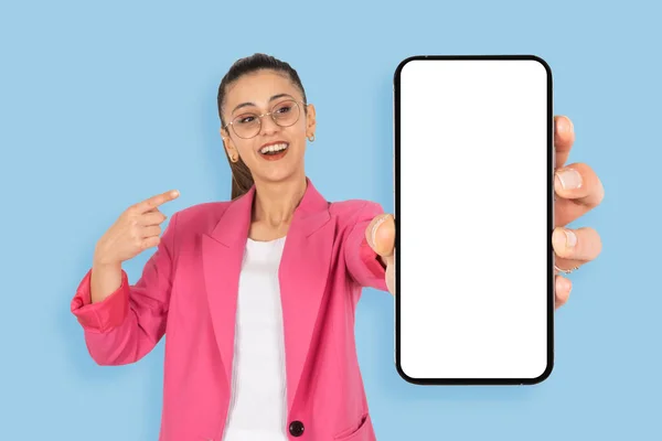 stock image Recommending new application, cheerful pretty brunette business woman recommending new application. Young caucasian lady showing holding big blank cell phone smartphone empty white screen mockup.  