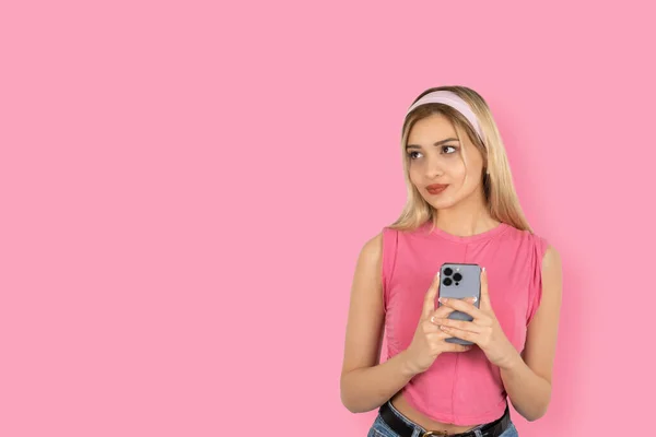 美しいブロンドの女の子の肖像画は コピースペースエリアを見ながらインターネットを閲覧する携帯電話を微笑みます アプリケーション広告バナーデザインコンセプトイメージ スタジオショット — ストック写真