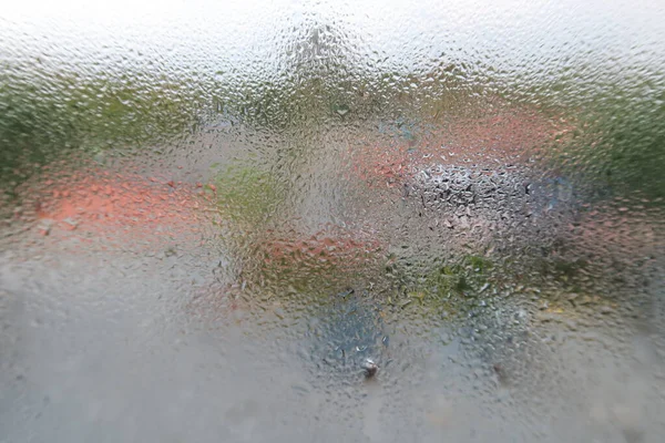 Glass with water vapor, fog, flow. a window with water drops. fogged glass