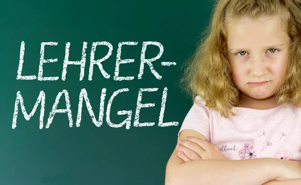 Pupil in front of a blackboard with the German word: Lehrermangel (teacher shortage)