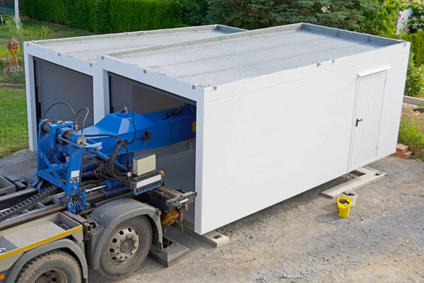 stock image The second half of a prefabricated garage is placed on the strip foundation