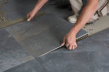 A tiler laid floor tile clipart