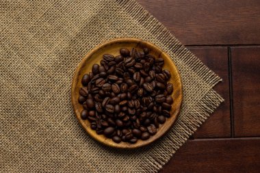 fresh coffee beans - coffee beans on wooden plate