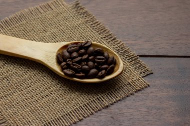coffee beans on wooden spoon - fresh coffee beans