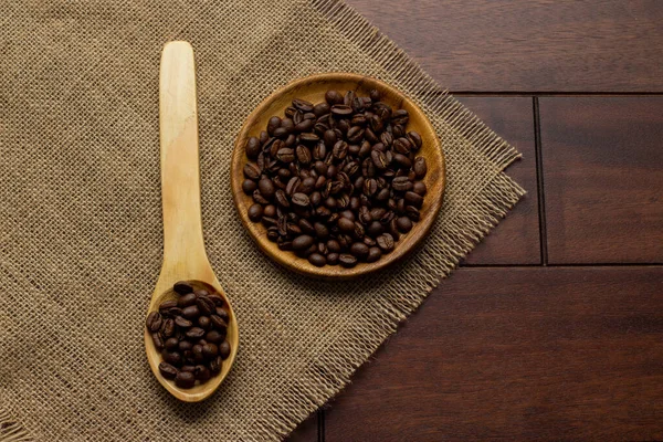 fresh coffee beans - coffee beans on wooden plate