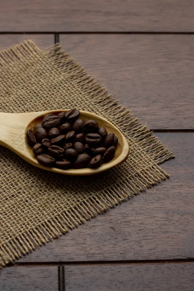 fresh coffee beans - coffee beans on wooden spoon
