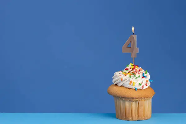 stock image Birthday cupcake on blue background - pink birthday candle number