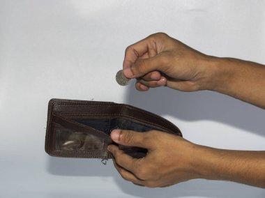 jakarta, Endonezya - 08 Kasım 2022: Bir adamın eli beyaz arka planda izole edilmiş cüzdandan para alır ve gösterir, rupiah Endonezya 'nın para birimidir.