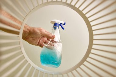 Expired detergent is thrown into the trash for disposal and recycling. View from below. The concept of utilization and processing of waste.