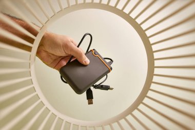 The external hard drive is discarded and recycled in the trash. View from below. The concept of disposal and recycling.