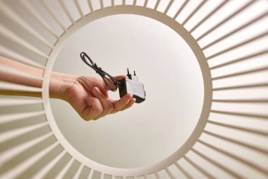 Chargers for smartphone batteries are disposed of and recycled in the trash. View from below. The concept of disposal and recycling of waste.