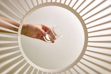 The old glass jar is thrown into the trash for disposal and recycling. View from below. The concept of disposal and processing of waste.