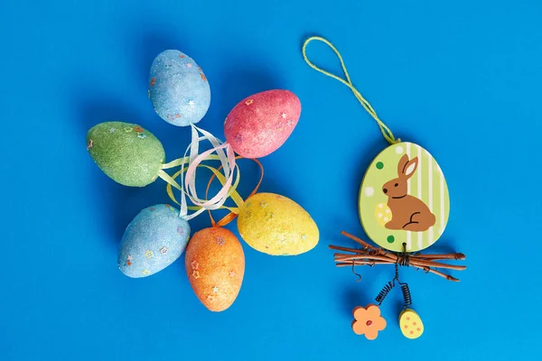 Easter eggs and beauty rabbit on a blue background. Easter celebration. Easter background.
