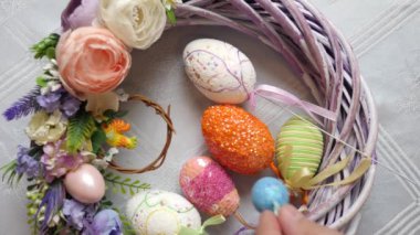 Easter eggs are placed in the middle of the festively decorated wreath. Easter celebration. Happy Easter.
