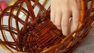 People put different Easter eggs in the basket. Celebrating Easter in the family. Easter games and fun.