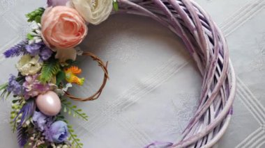 Easter eggs are placed in the middle of the festively decorated wreath. Easter celebration. Happy Easter.