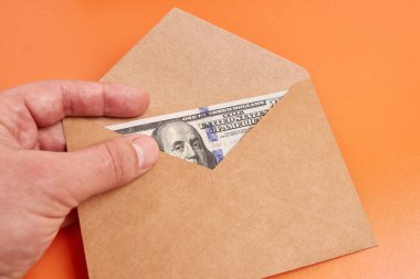 A brown envelope with a $100 bill inside.