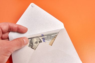A gray envelope with a $100 bill inside.