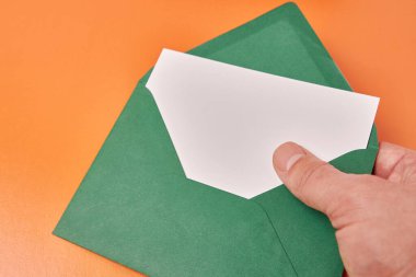 They hold an envelope with a white sheet in their hands. Banner for advertising.