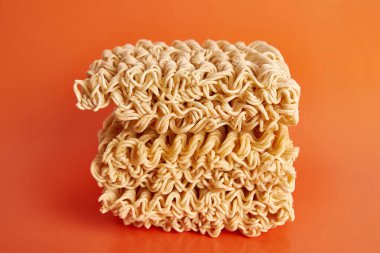 Instant vermicelli on an orange background. Instant food.