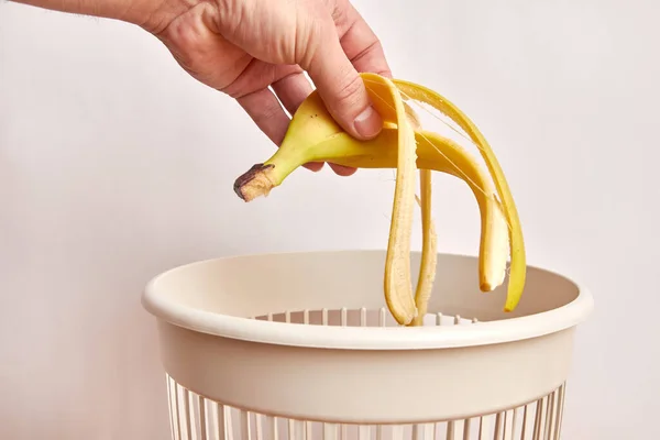 Banana peels are thrown into the trash. Disposal and recycling of food products.