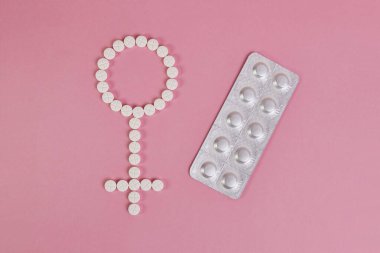 Venüs 'ün sembolü olan dişi işareti haplardan yayılmış. Kadın sağlığının işaretleri ve sembolleri.