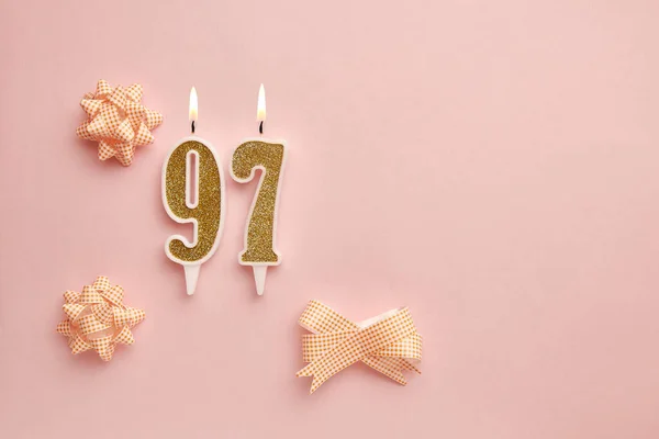 带有97号的蜡烛 粉红的背景上有节日装饰 生日快乐蜡烛 庆祝生日 周年纪念日 重要日期 假日的概念 复制空间 — 图库照片