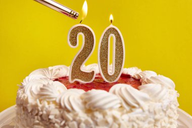 20 numara şeklinde bir mum, şenlikli bir pastaya sıkıştı ve yakıldı. Bir doğum gününü ya da tarihi bir olayı kutluyoruz. Kutlamanın doruk noktası..