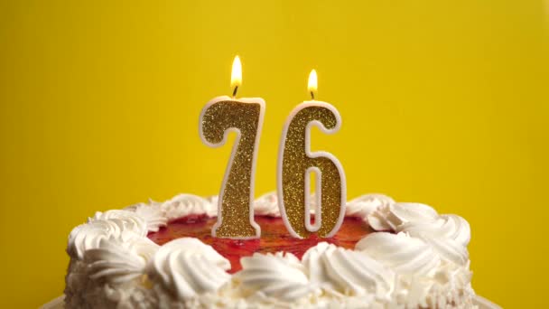 休日のケーキに詰め込まれた76番の形のキャンドルが吹き飛ばされます 誕生日やランドマークイベントを祝う お祝いのクライマックス — ストック動画