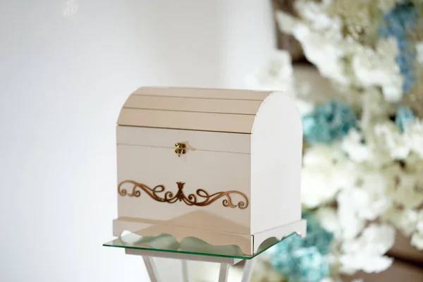 A beautiful white wooden box for money and gifts for newlyweds. Wedding celebration.