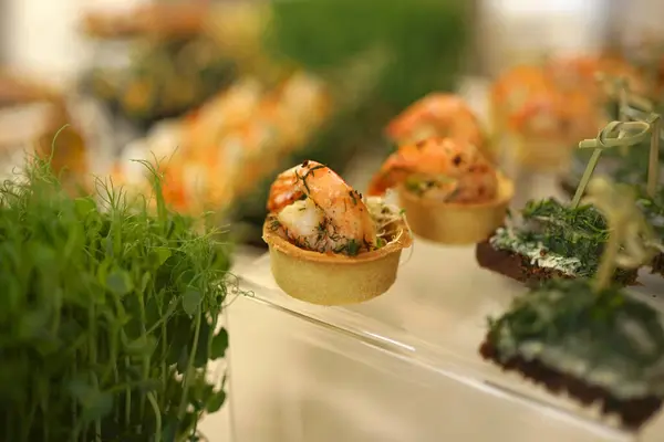 Sandwiches with shrimp on the buffet. Decoration of the festive table.