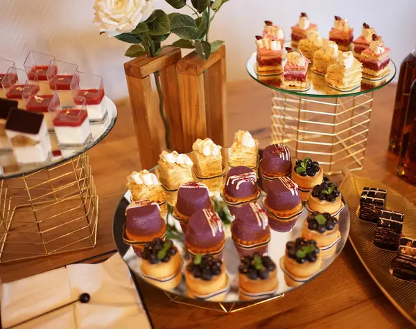 Sweet cakes with filling laid out on a glass stand.
