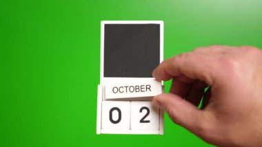 2 Ekim tarihli takvim yeşil arka planda. Belirli bir tarihteki olay için illüstrasyon.