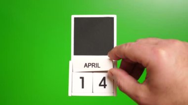14 Nisan tarihli takvim yeşil arka planda. Belirli bir tarihteki olay için illüstrasyon.