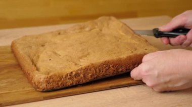 Fırınlanmış kek dolgu için uzunlamasına kesilir. Yavaş çekim.