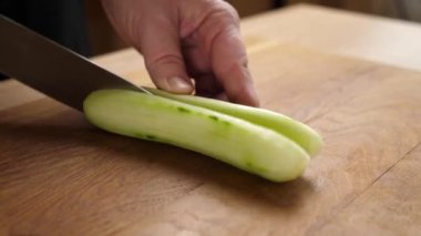 Taze salatalık yemek pişirmek için parçalara ayrılır. Salatalık pişiriyorum.