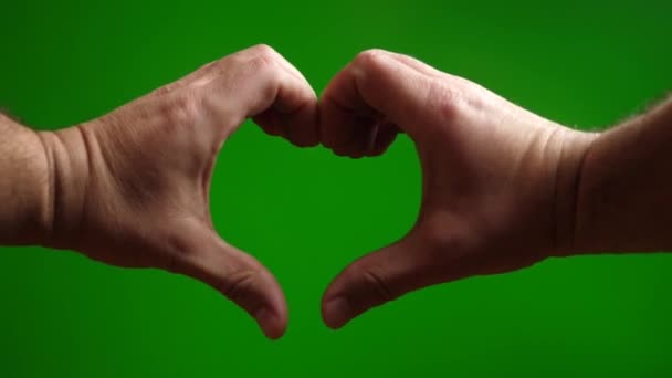Pomocą Dwóch Rąk Zrobić Obraz Serca Zielonym Tle — Wideo stockowe