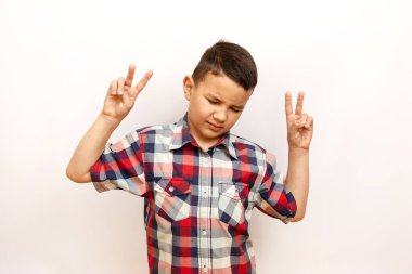 The boy closed his eyes with delight and raised his hands in victory. clipart
