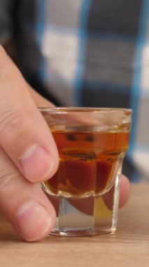 Adam bir bardak içki içer ve arabanın anahtarlarını alır. Alkolün etkisi altında araba kullanma kavramı. Dikey video