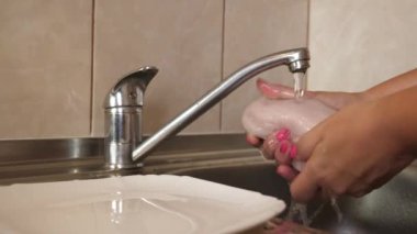 Suyun altında bir parça et yıka. Et yemeklerinin hazırlanması.