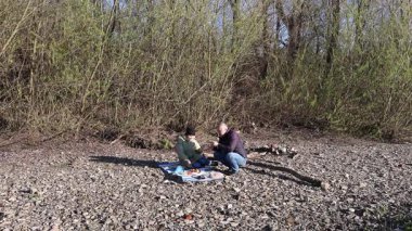 Bir erkek ve bir kadın doğada piknik yaptılar. Doğada aktif eğlence..