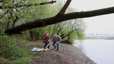 Bir erkek ve bir kadın doğada piknik yaptılar. Doğada aktif eğlence..