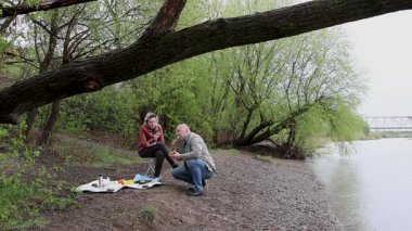 Bir erkek ve bir kadın doğada piknik yaptılar. Doğada aktif eğlence..