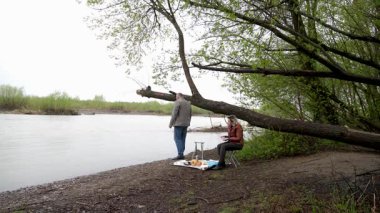 Bir erkek ve bir kadın doğada piknik yaptılar. Doğada aktif eğlence..