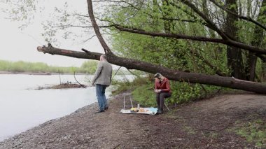 Bir erkek ve bir kadın doğada piknik yaptılar. Doğada aktif eğlence..