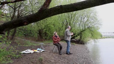 Bir erkek ve bir kadın doğada piknik yaptılar. Doğada aktif eğlence..
